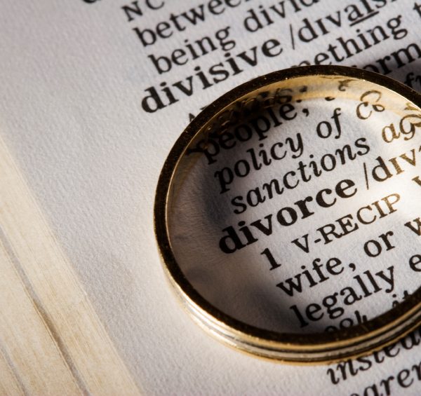 Photo of a magnifying glass over a dictionary definition of divorce | Featured image for the Understanding the Difference Between Separation and Divorce blog from Barton Family Lawyers.