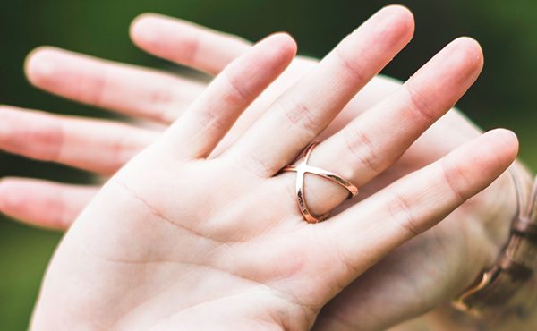 Photo of two crossed hands | Featured image for the Is Domestic Violence Relevant in a Property Settlement blog from Barton Family Lawyers.